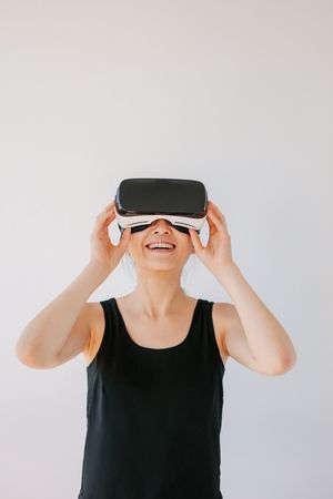 Vertical shot of young woman using the virtual reality device