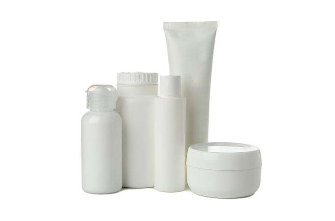 Blank bottles for cosmetics isolated on light background