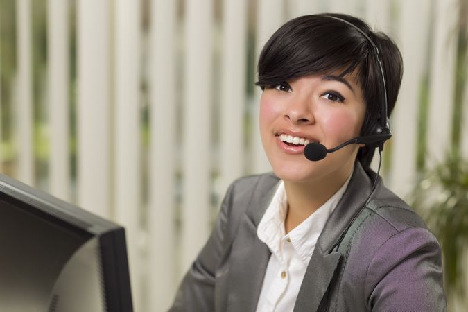 Happy Woman Smiles Wearing Headset