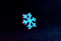Snowflake in vivid neon colors on dark  background