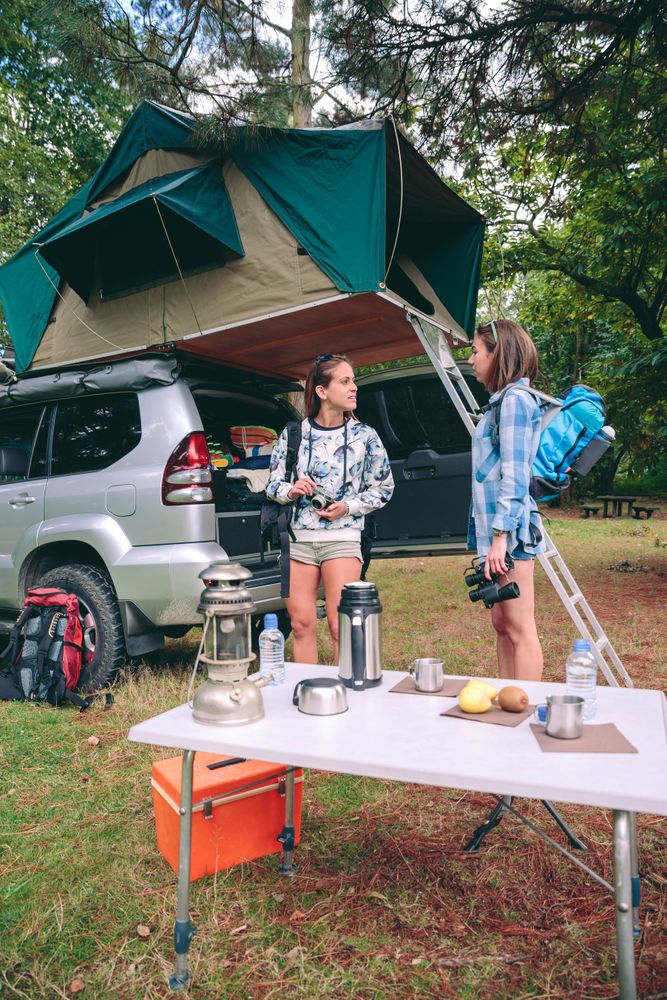 Young women ready for hiking trip with 4x4 on background