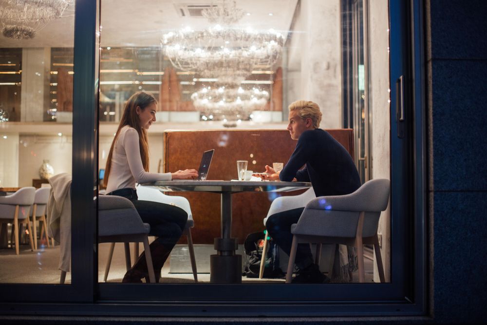Man and woman having a casual study session in a restaurant