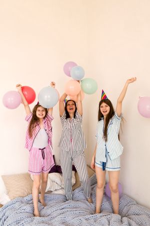 Family celebrating with balloons, joyous party at home