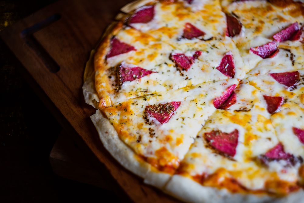 Close up of pizza with slices of meat