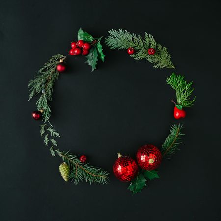 Christmas wreath made with green tree branches and red berries