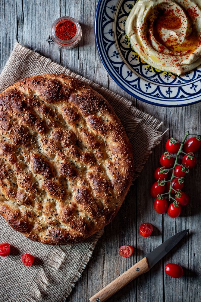 Ramazan pidesi near spices and tomatoes