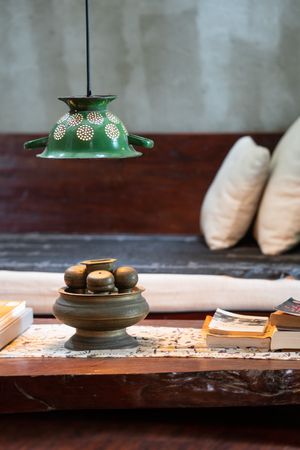 Table with books in bedroom of old cottage