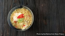 Top view of bowl of instant ramen noodles with egg and vegetables bEY67b