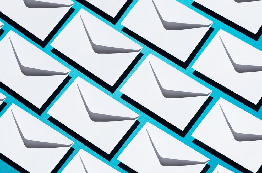 Many light envelopes over teal background