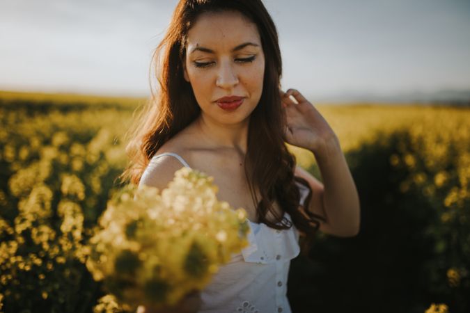 Woman with flowers in field