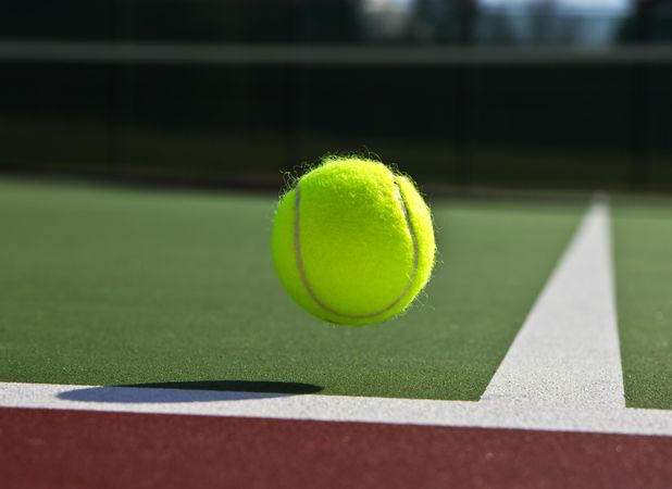 Tennis ball bouncing off the baseline