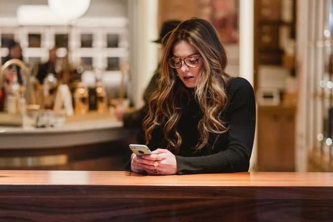 Female using smartphone in cafe