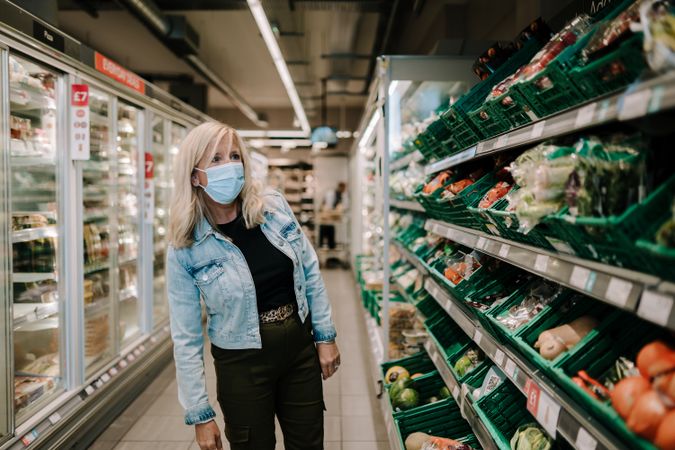 Grey haired woman in the produce aisle