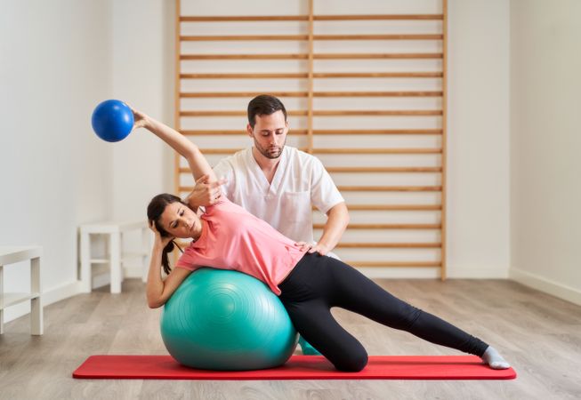 The physiotherapist doing rehabilitation exercises with the pati