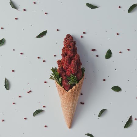 Ice cream cone with red flowers and leaves