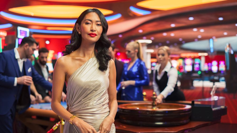 In a Modern Casino Hall: Asian Brunette Woman Posing Confidently, Looking at Camera