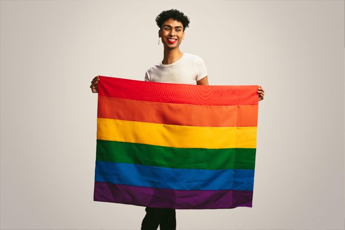 Smiling man with pride flag