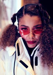 Close up of young woman wearing red sunglasses