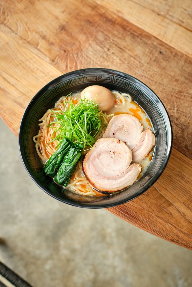 Delicious Asian soup with noodles and rolled chicken served in bowl