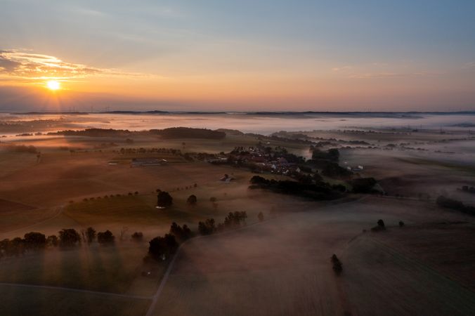 Drone aerial view of a foggy morning at sunrise in a german rural scenery