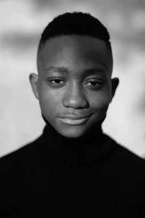 Monochrome portrait of man smiling wearing a turtle neck sweater