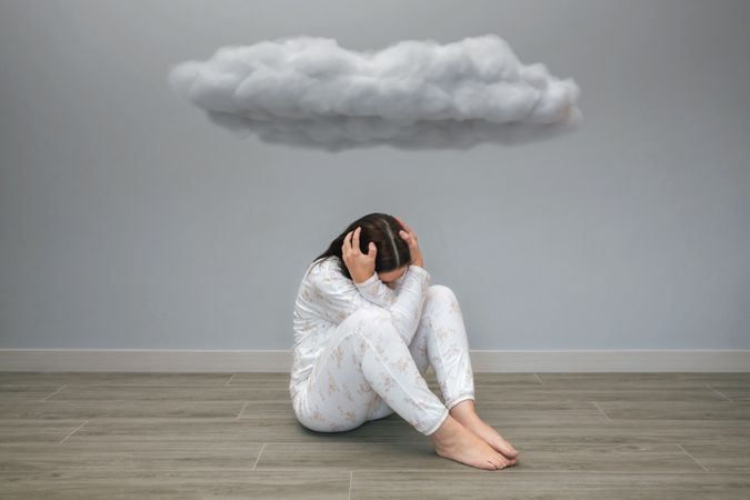 Unrecognizable woman thoughts under a dark cloud
