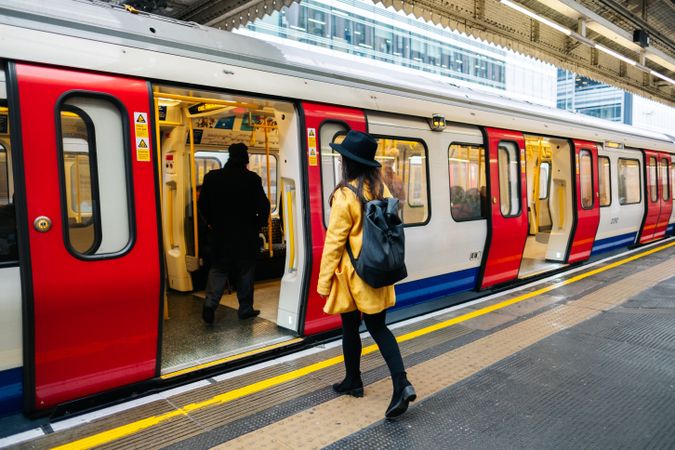 Cheerful woman catching train on station
