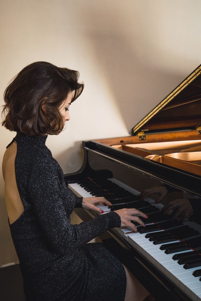 Young woman playing on piano