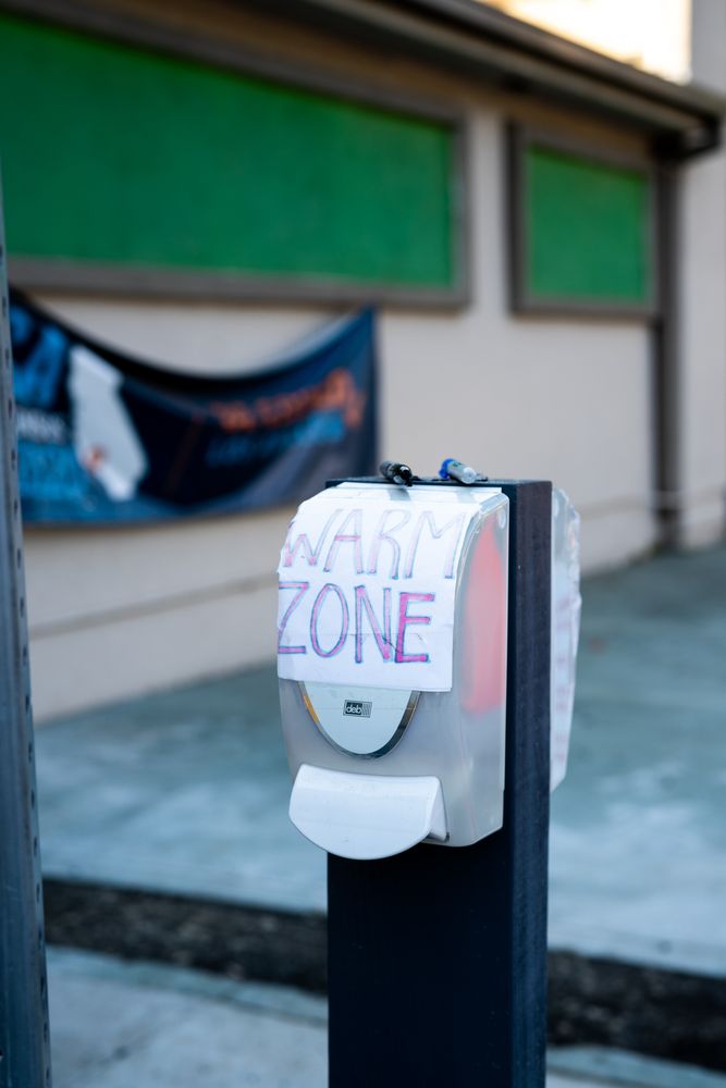 Handmade sign indicating “warm zone” for healthcare workers at public Covid testing site