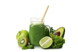 Green vegetables, fruits and jar of smoothie isolated on blank background