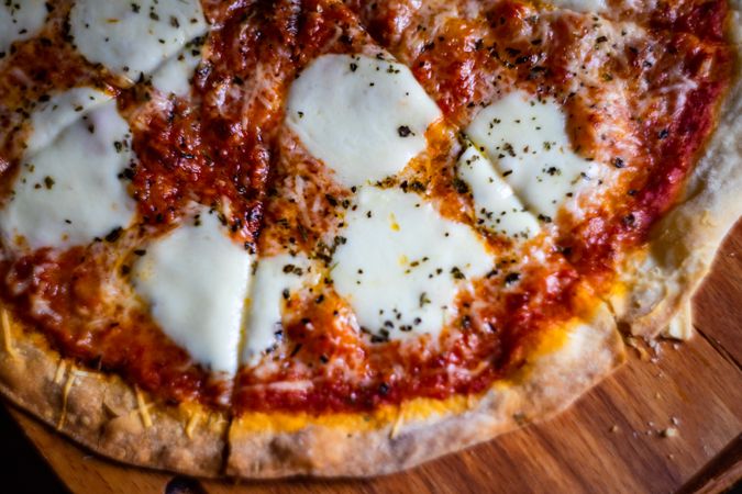 Top view of cheese pizza on wooden board