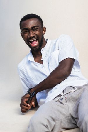 Optimistic Black man laughing at camera