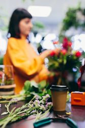 Florist's equipment and woman composing bouquet