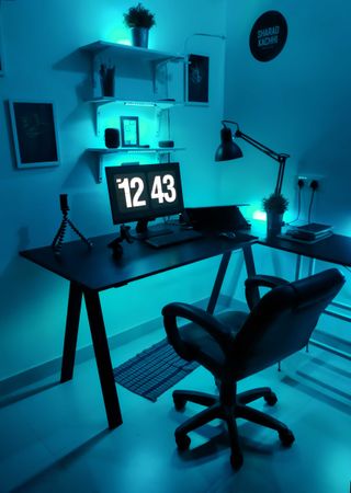 Desktop computer on a desk in a blue lit room