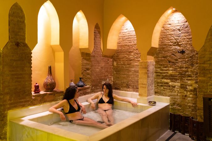Female friends bathing together in Arabic bathhouse
