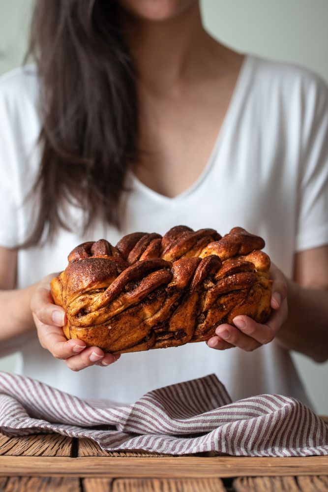 Faceless woman with appetizing cinnamon babka