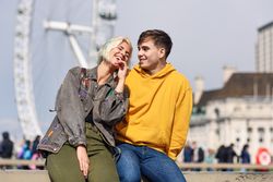 Cute couple relaxing in front of London Eye