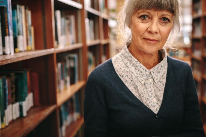 Portrait of a mature woman standing in a library