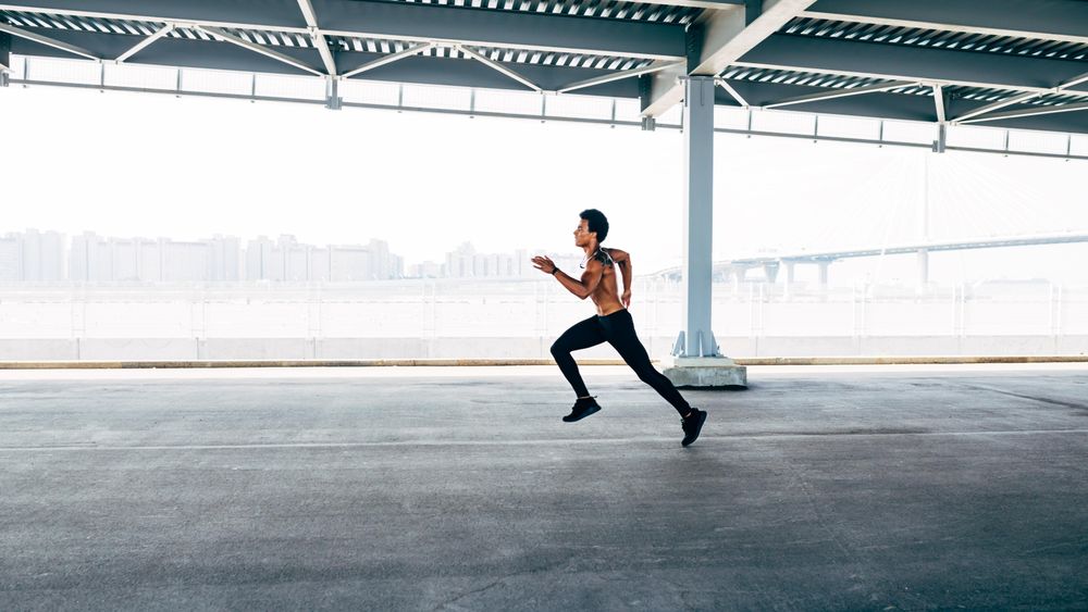 Athletic man sprinting during a bridge