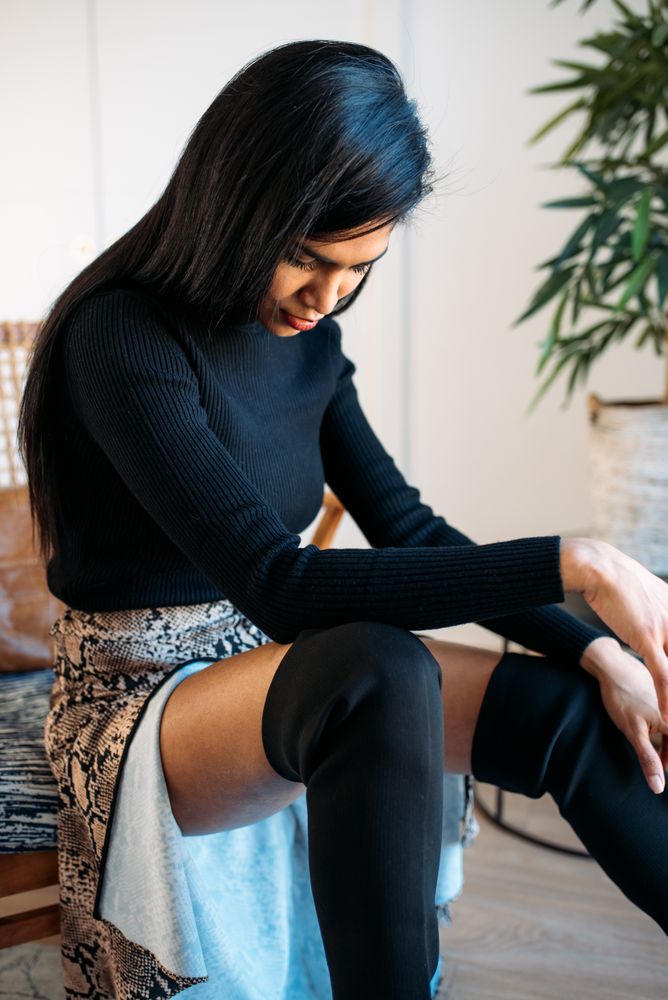 Stylist beautiful young Black woman sitting in a chair