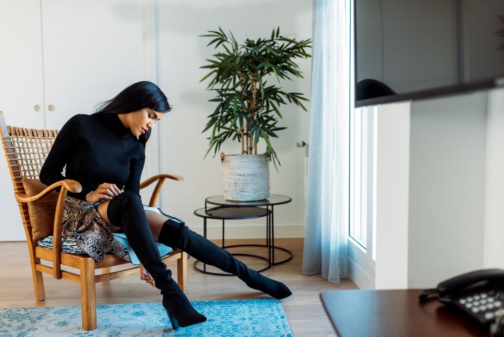Stylist beautiful young Black woman sitting in a chair