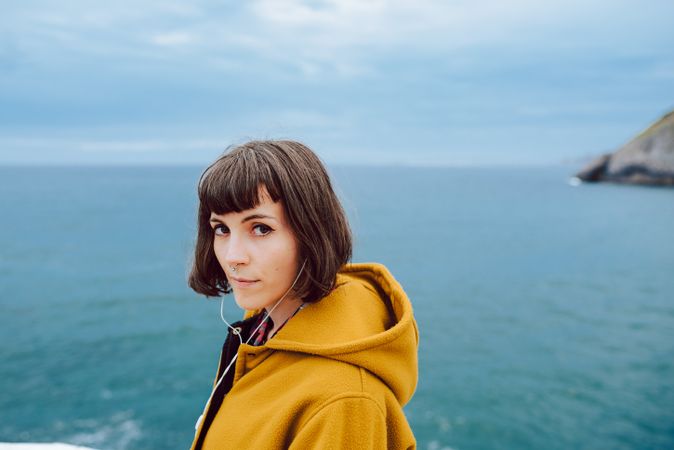 Young woman standing near sea