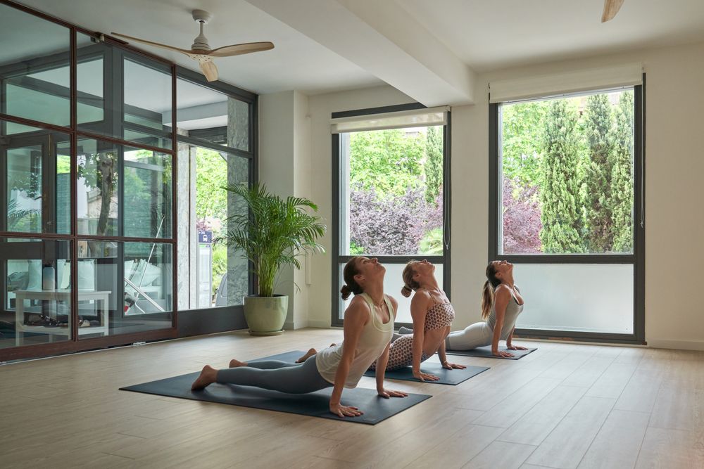 Female athletes taking Cobra pose during yoga session
