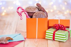 Open gift on wooden table and letters