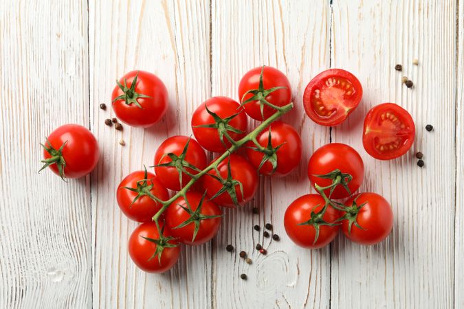 Tomatoes and pepper on wooden background, top view