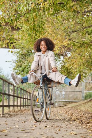Young female enjoying bike ride on pathway