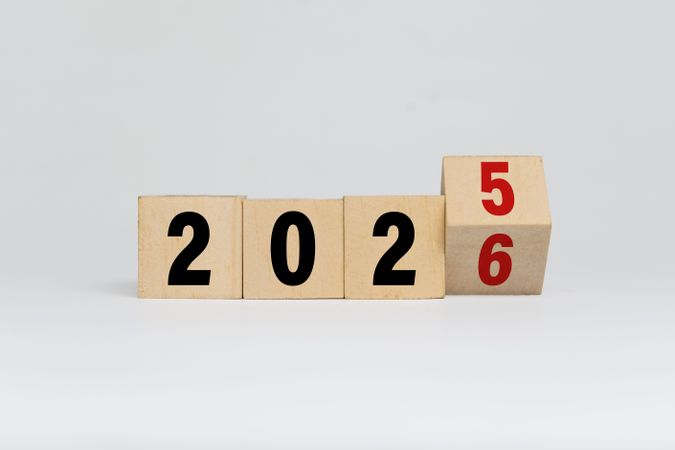 flip wooden blocks with year 2025 to 2026 isolated on plain background