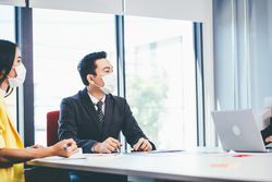 Manager discussing company project with staff in boardroom