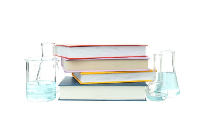 Books and flasks isolated, on light background