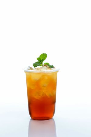 Iced Tea with Mint Leaf on Top, Isolated on Plain Table